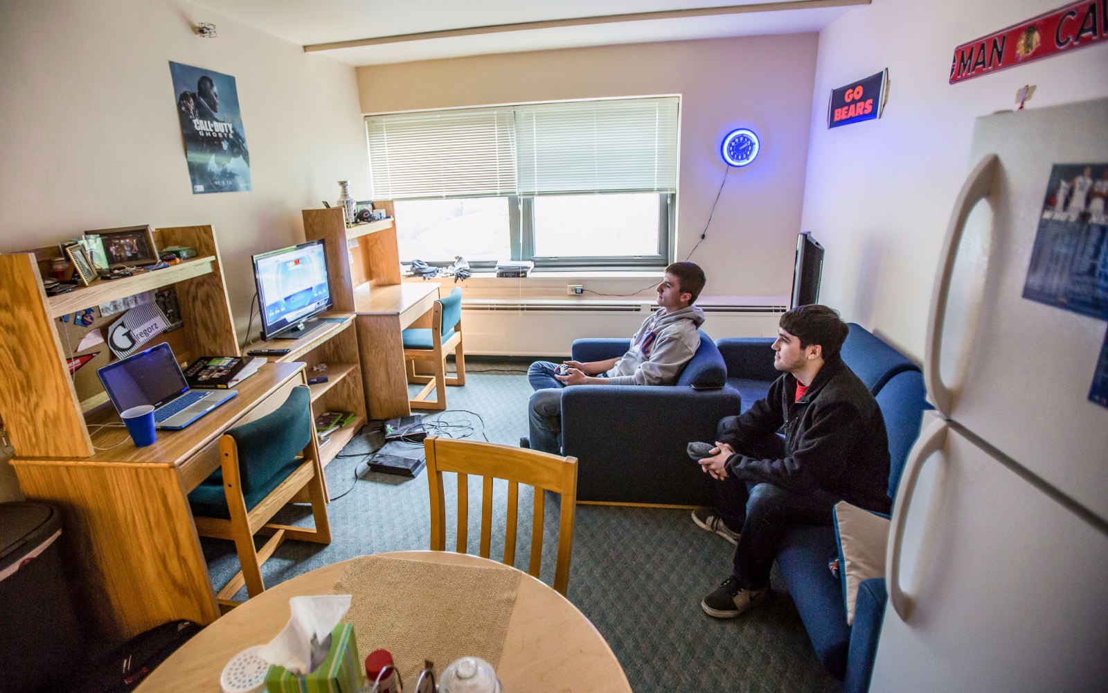 Students talking in a dorm room.