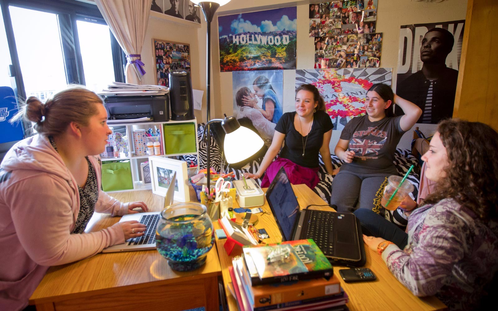 A group of students talking in a dorm room.