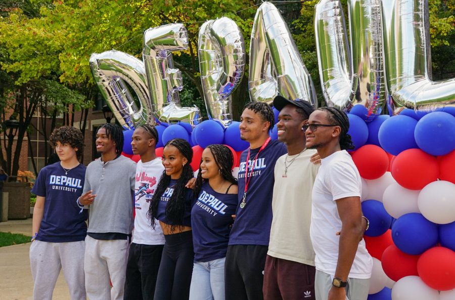 Students holding flags at Blue Demon Welcome
