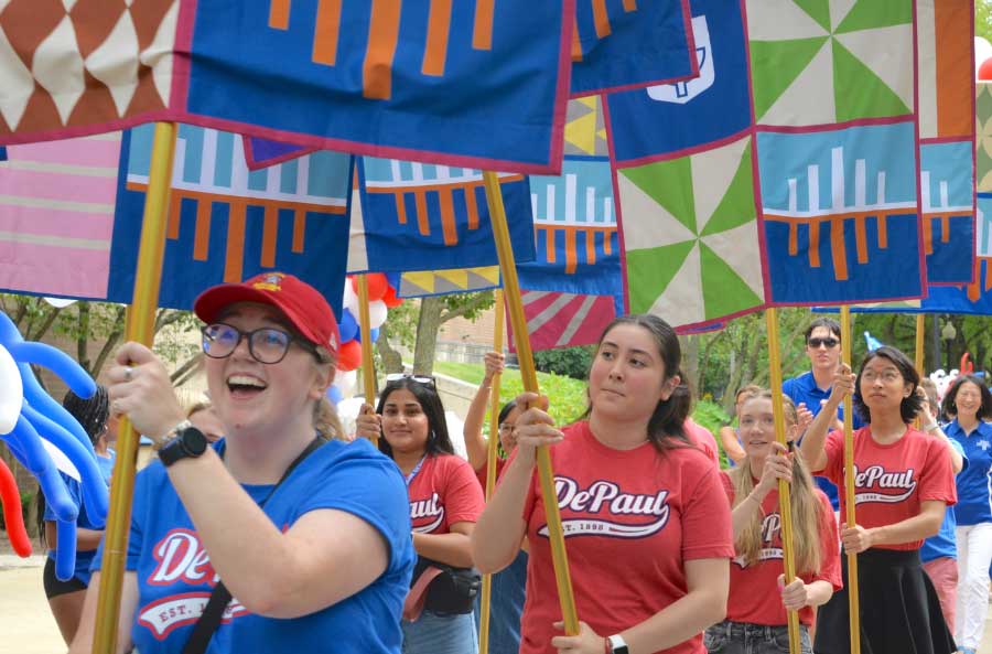 Students holding flags at Blue Demon Welcome